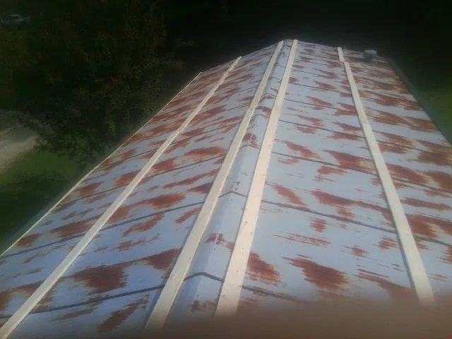 Rusted metal roof panels with new wood purlins before replacement — Storm Damage Roof Repair in Danielsville by Roofing Brothers